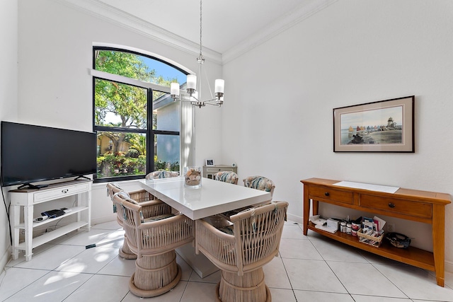 dining area with a chandelier, light tile patterned flooring, and crown molding