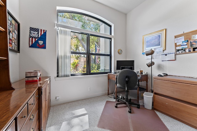 home office with carpet floors and baseboards