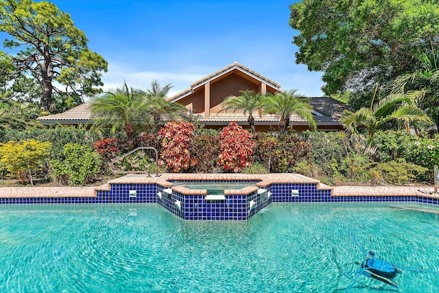 view of swimming pool with a pool with connected hot tub