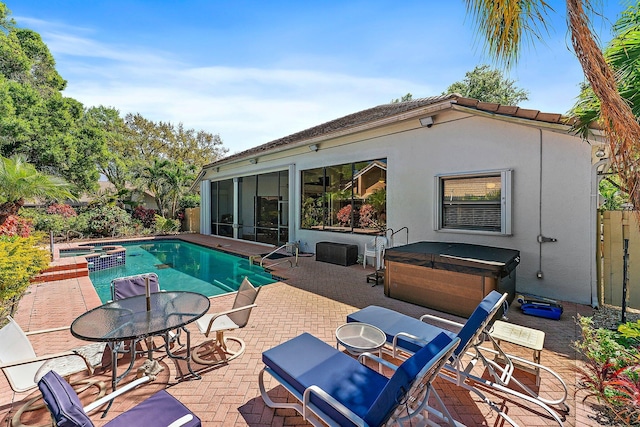 pool featuring a patio area and a hot tub