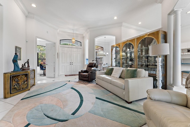 living area with ornate columns, tile patterned flooring, crown molding, and recessed lighting