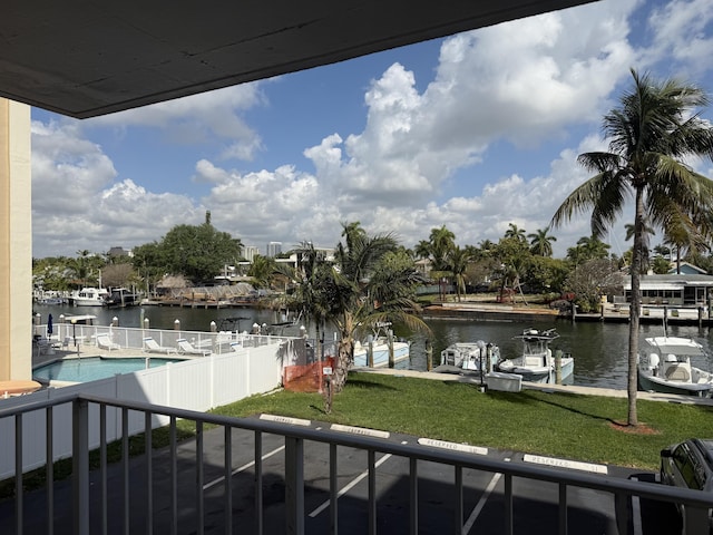 balcony with a dock and a water view