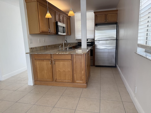 kitchen with a sink, appliances with stainless steel finishes, and brown cabinets