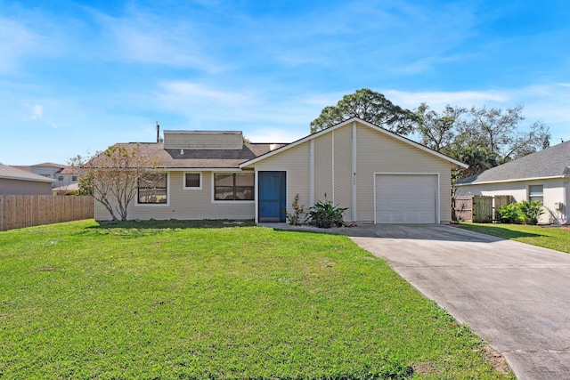 view of front of property featuring an attached garage, fence, driveway, roof mounted solar panels, and a front yard