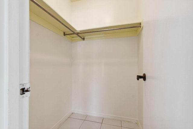 spacious closet with light tile patterned floors