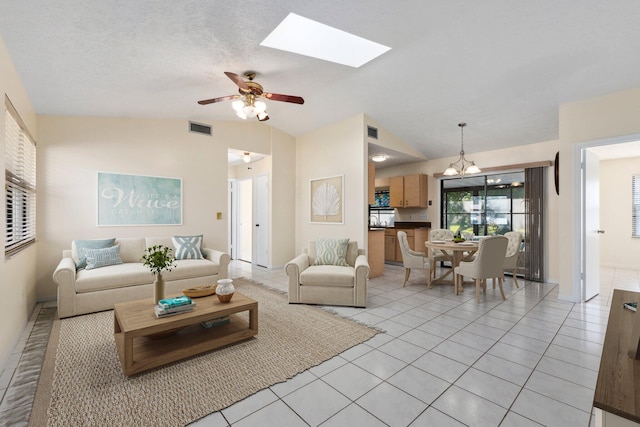 living room with lofted ceiling, visible vents, and light tile patterned flooring