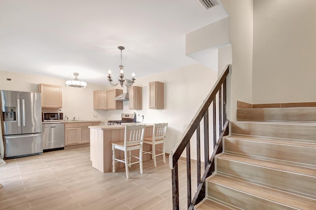 kitchen with light brown cabinets, stainless steel appliances, a breakfast bar, light countertops, and an inviting chandelier