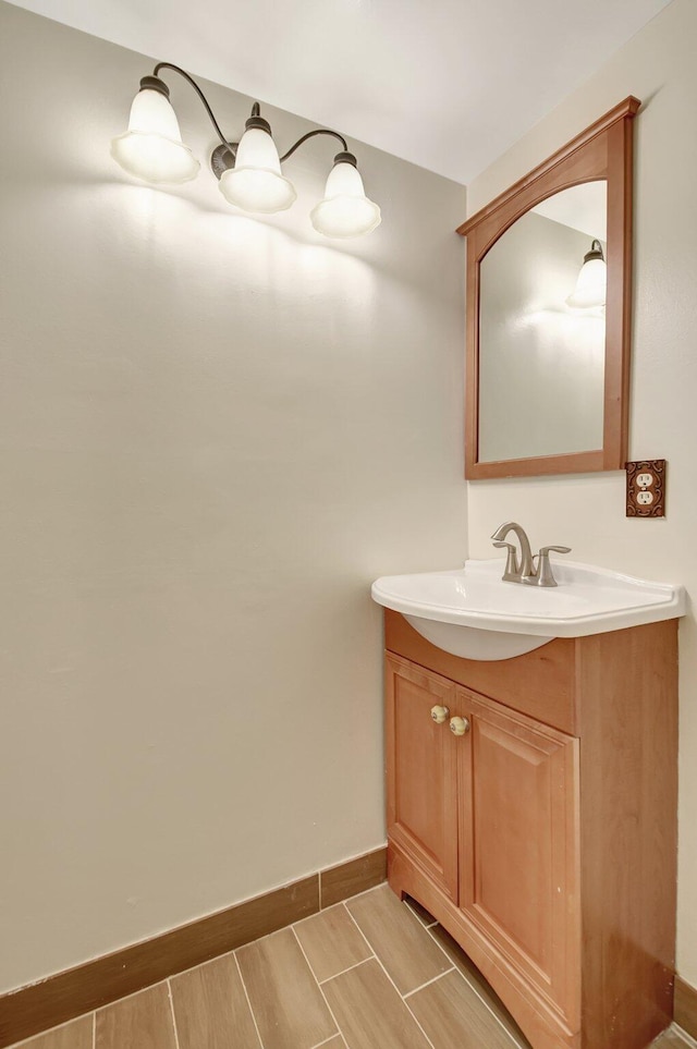 bathroom with vanity and baseboards