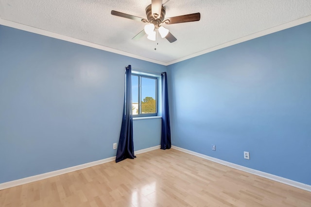 unfurnished room with baseboards, a ceiling fan, ornamental molding, a textured ceiling, and light wood-type flooring