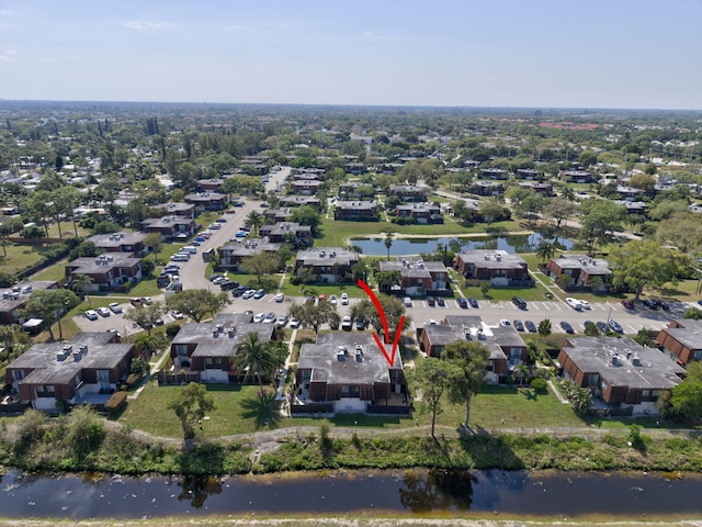 birds eye view of property with a water view and a residential view