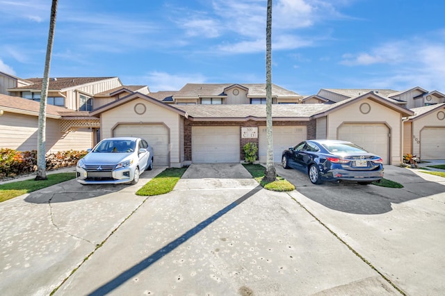 townhome / multi-family property featuring a garage and concrete driveway