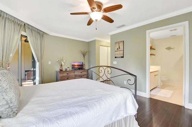 bedroom with visible vents, baseboards, a closet, dark wood finished floors, and crown molding