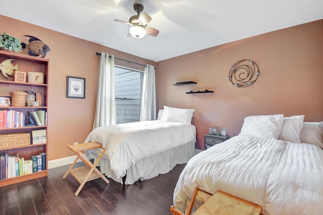 bedroom with ceiling fan, baseboards, and wood finished floors