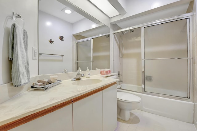 bathroom featuring toilet, shower / bath combination with glass door, tile patterned floors, and vanity