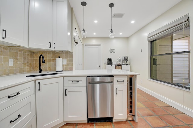 kitchen with tasteful backsplash, visible vents, dishwasher, a peninsula, and a sink