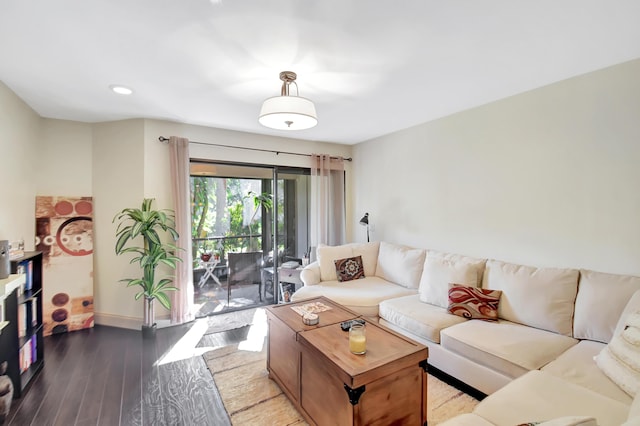 living room featuring baseboards, wood finished floors, and recessed lighting