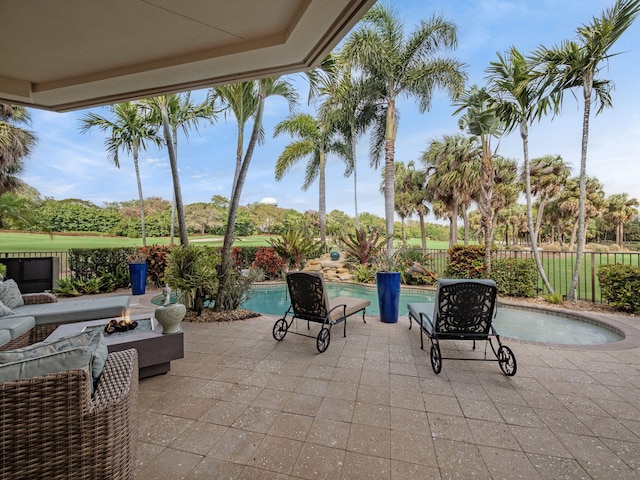 view of patio / terrace with an outdoor fire pit, a fenced backyard, and a fenced in pool