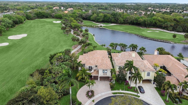 birds eye view of property featuring view of golf course and a water view