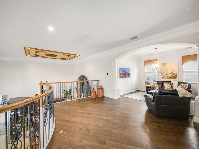 hallway with ornate columns, visible vents, arched walkways, and wood finished floors