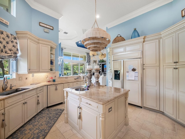 kitchen with cream cabinets, a sink, and crown molding