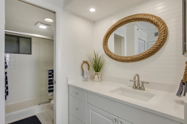 full bath featuring toilet, recessed lighting, visible vents, vanity, and a shower stall