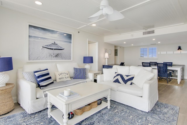 living area with a ceiling fan, visible vents, wood finished floors, and recessed lighting