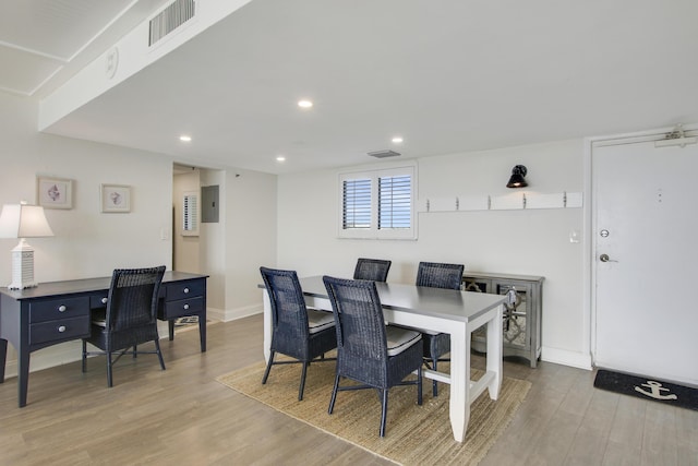 dining area featuring baseboards, wood finished floors, visible vents, and recessed lighting