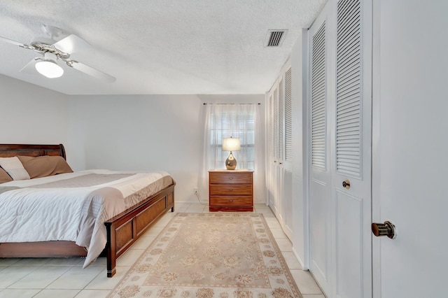 233 Down E Ln, Lake Worth, FL 33467 - bedroom featuring a textured ceiling, light tile patterned floors, a ceiling fan, and baseboards