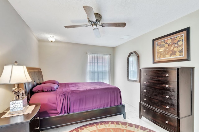 233 Down E Ln, Lake Worth, FL 33467 - bedroom with light tile patterned floors, a textured ceiling, and a ceiling fan