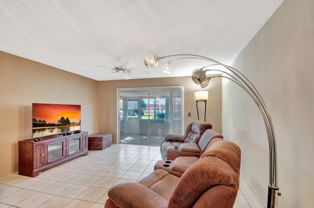 living area with a textured ceiling, light tile patterned flooring, and a ceiling fan