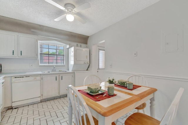233 Down E Ln, Lake Worth, FL 33467 - kitchen featuring dishwasher, stacked washer and clothes dryer, a sink, light countertops, and ceiling fan