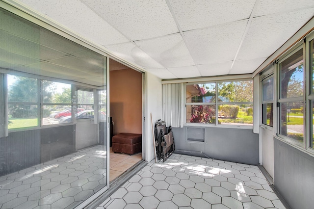 unfurnished sunroom featuring a wealth of natural light and a paneled ceiling