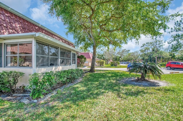 view of yard with a sunroom