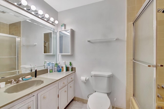 full bathroom featuring tile patterned flooring, baseboards, vanity, and toilet