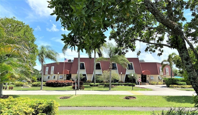 view of front of house featuring a front yard and a tiled roof