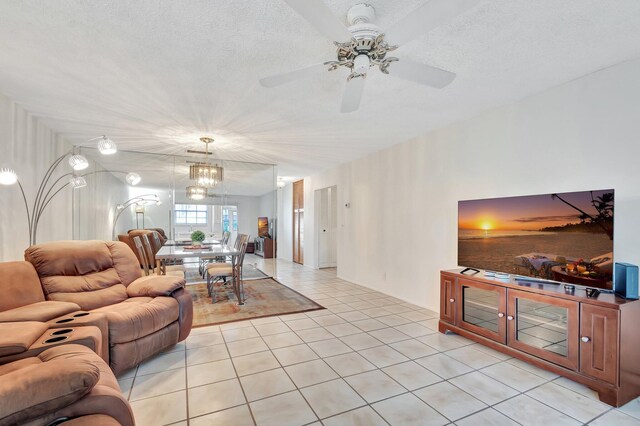 233 Down E Ln, Lake Worth, FL 33467 - living area featuring light tile patterned flooring, a ceiling fan, and a textured ceiling