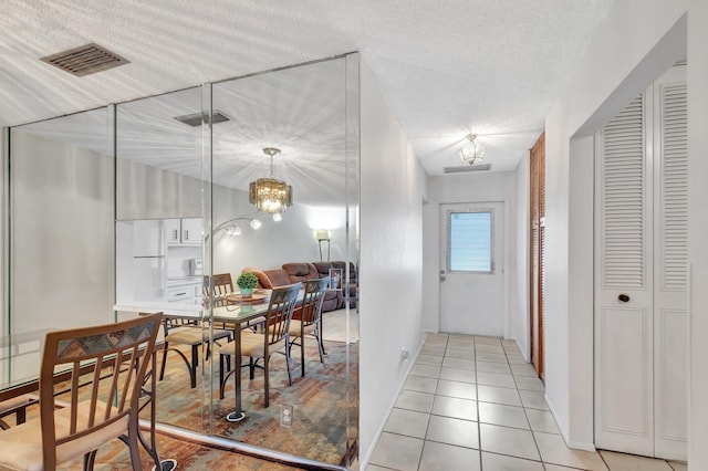 233 Down E Ln, Lake Worth, FL 33467 - dining area featuring light tile patterned floors and a chandelier
