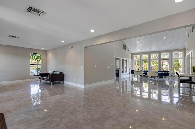 living area with lofted ceiling, marble finish floor, baseboards, and visible vents