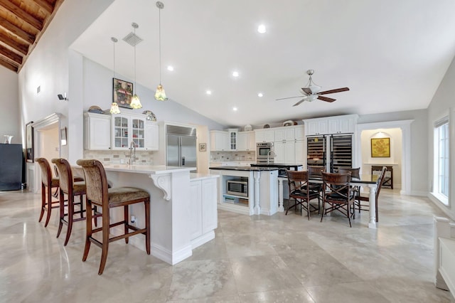 kitchen featuring stainless steel appliances, a breakfast bar area, and tasteful backsplash