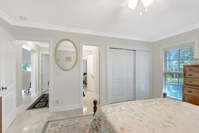 bedroom with a ceiling fan, baseboards, marble finish floor, ornamental molding, and a closet