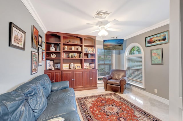 living area with visible vents, crown molding, baseboards, and ceiling fan