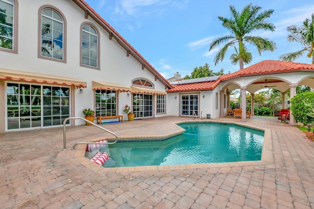 pool with a patio and fence