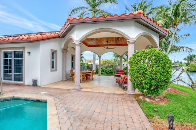 view of patio featuring a fenced in pool, fence, a ceiling fan, and outdoor dining space