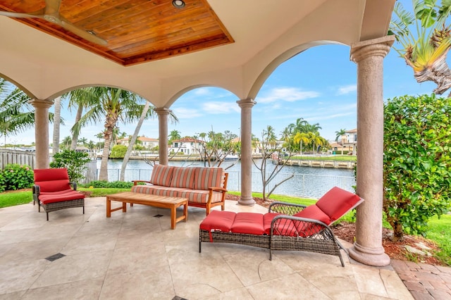 view of patio / terrace with a water view and fence