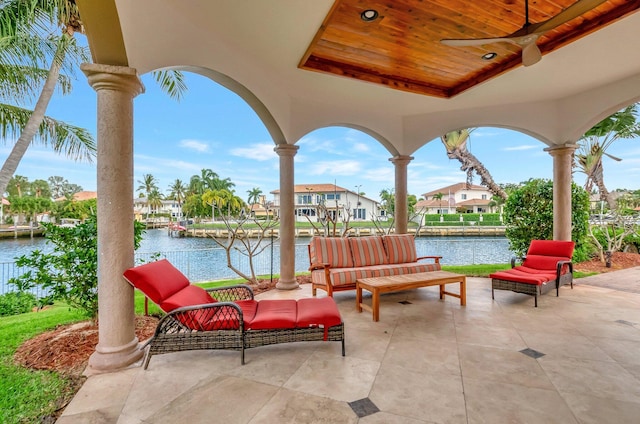 view of patio with a residential view and a water view