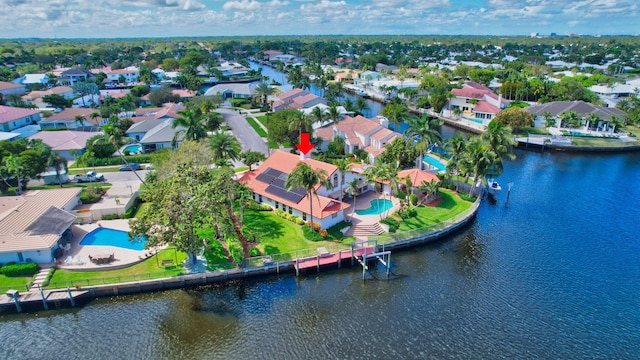 drone / aerial view featuring a water view and a residential view