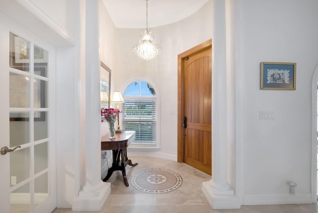 entrance foyer with a chandelier and tile patterned flooring