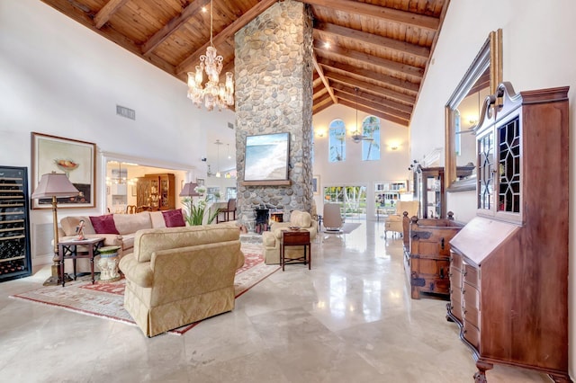 living room with wooden ceiling, a fireplace, beamed ceiling, and an inviting chandelier