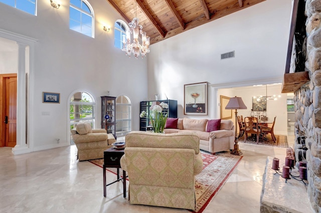 living room featuring decorative columns, visible vents, wood ceiling, beamed ceiling, and a chandelier