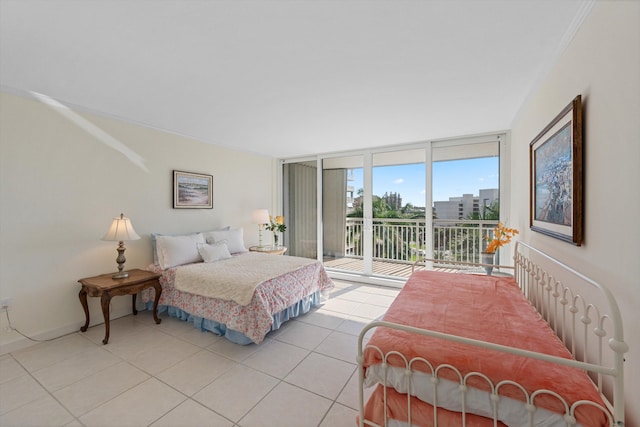 bedroom with access to exterior, light tile patterned flooring, baseboards, and a wall of windows